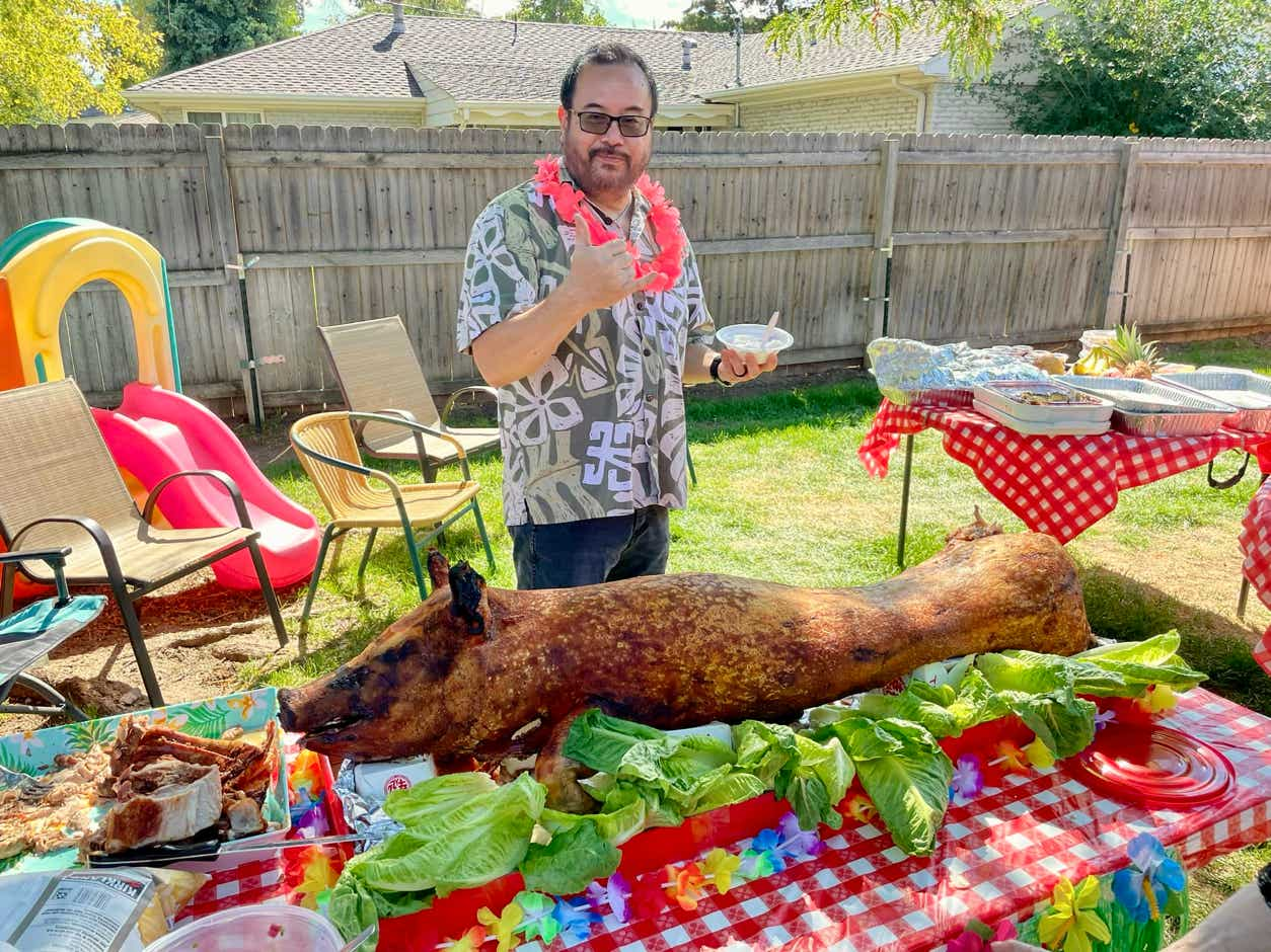 Pastor Shane at the luau with the pig